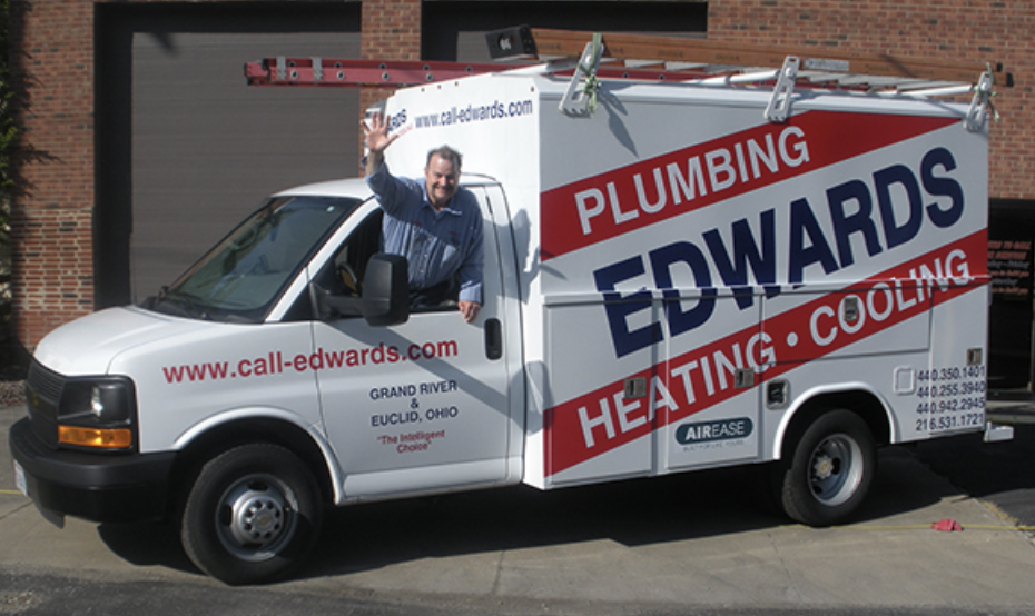 A picture of an Edwards Plumbing Heating and Cooling truck and an employee waving out the window