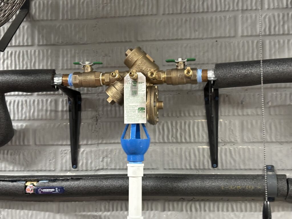 Zurn Wilkins reduced pressure zone backflow preventer with test ports and relief discharge.