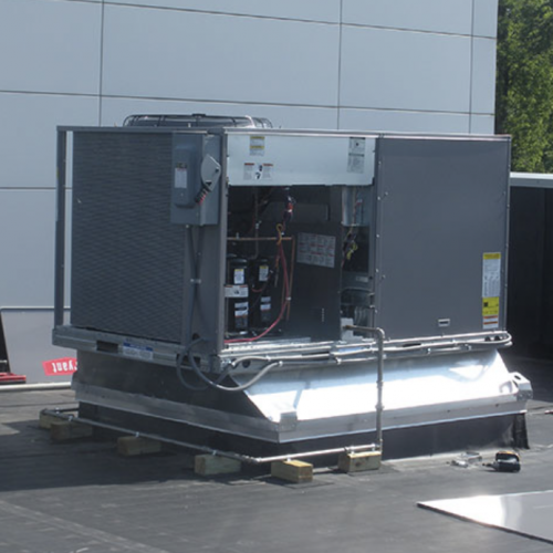 A picture of a commercial AC unit being worked on