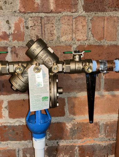 Zurn Wilkins backflow preventer repair with test ports and relief discharge.