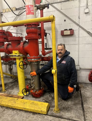 Large commercial backflow preventer assembly installed on industrial water service line.