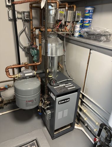 New Weil-McLain boiler installation with expansion tank and copper piping in Northeast Ohio home.
